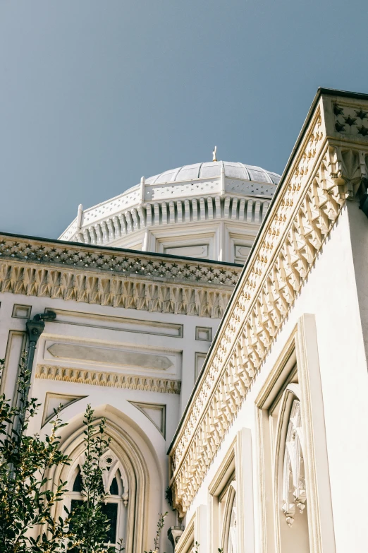 an ornate building in the city looking up at the roof