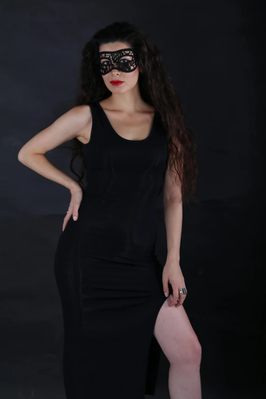 a woman in a black dress posing for the camera