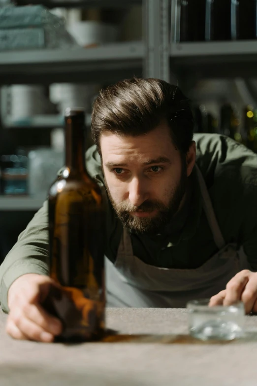 a man that is standing in front of some bottles