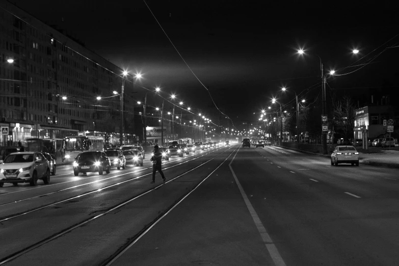 cars and people in the middle of city at night