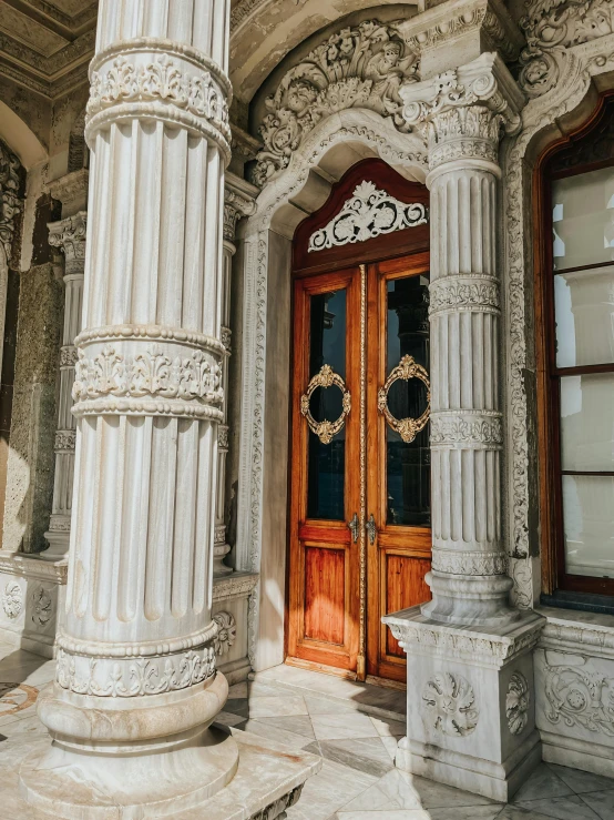 an ornate building has columns with wreaths on them