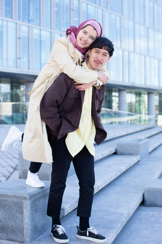 a couple standing in front of some steps