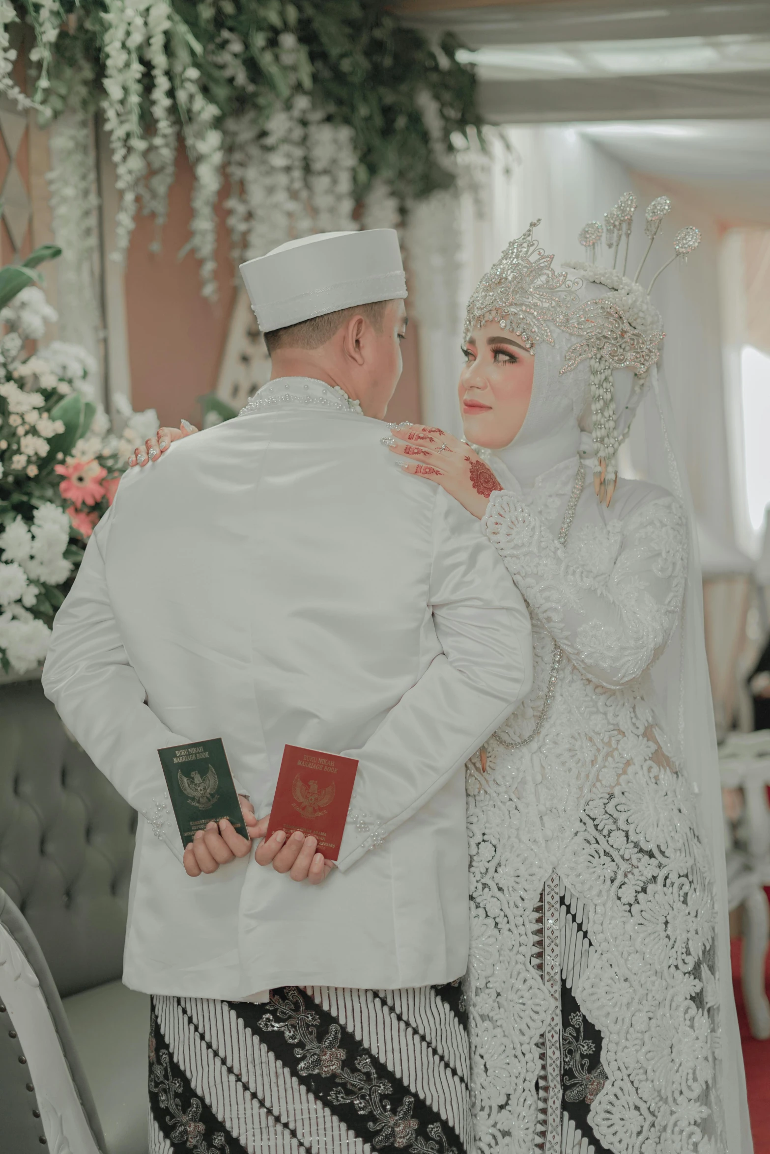 a woman dressed in white posing next to a man in a white outfit