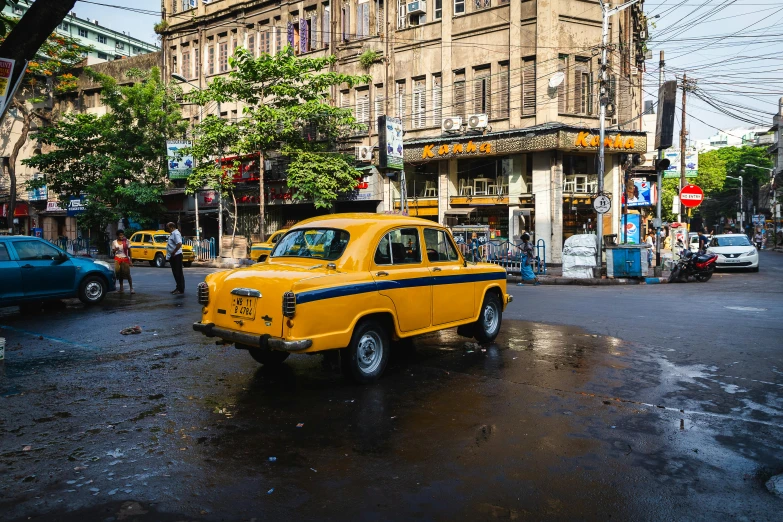 the taxi cab is driving on the wet street