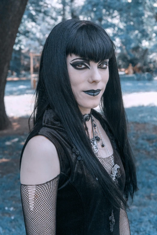 the black haired woman has her hair in goth style