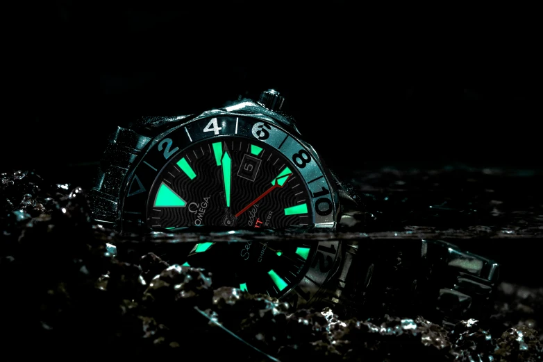 a dark background shows a close up view of a green light watch