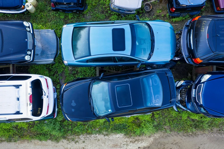 several small cars are parked in a yard