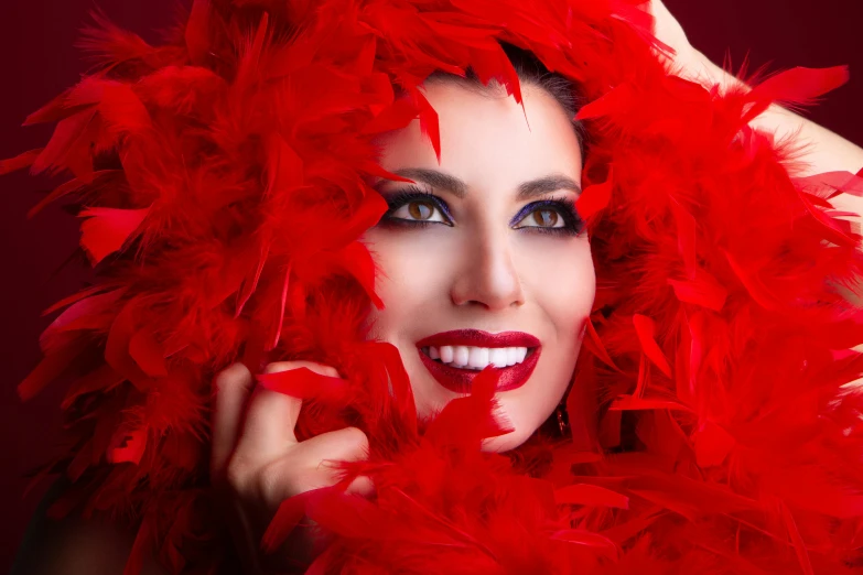 a woman wearing red feathers on her hair