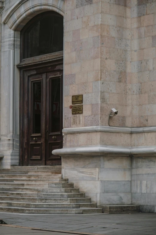 stairs lead to a building entrance with brick and stone