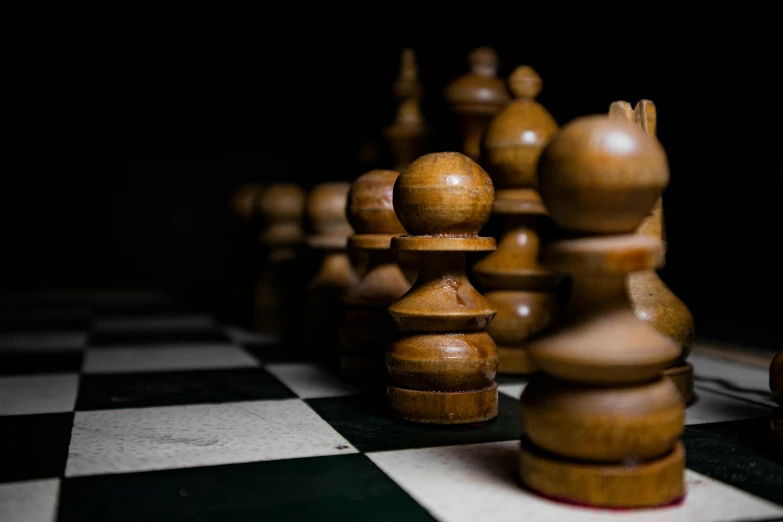 a game of chess with a single pawn placed in front of the figures