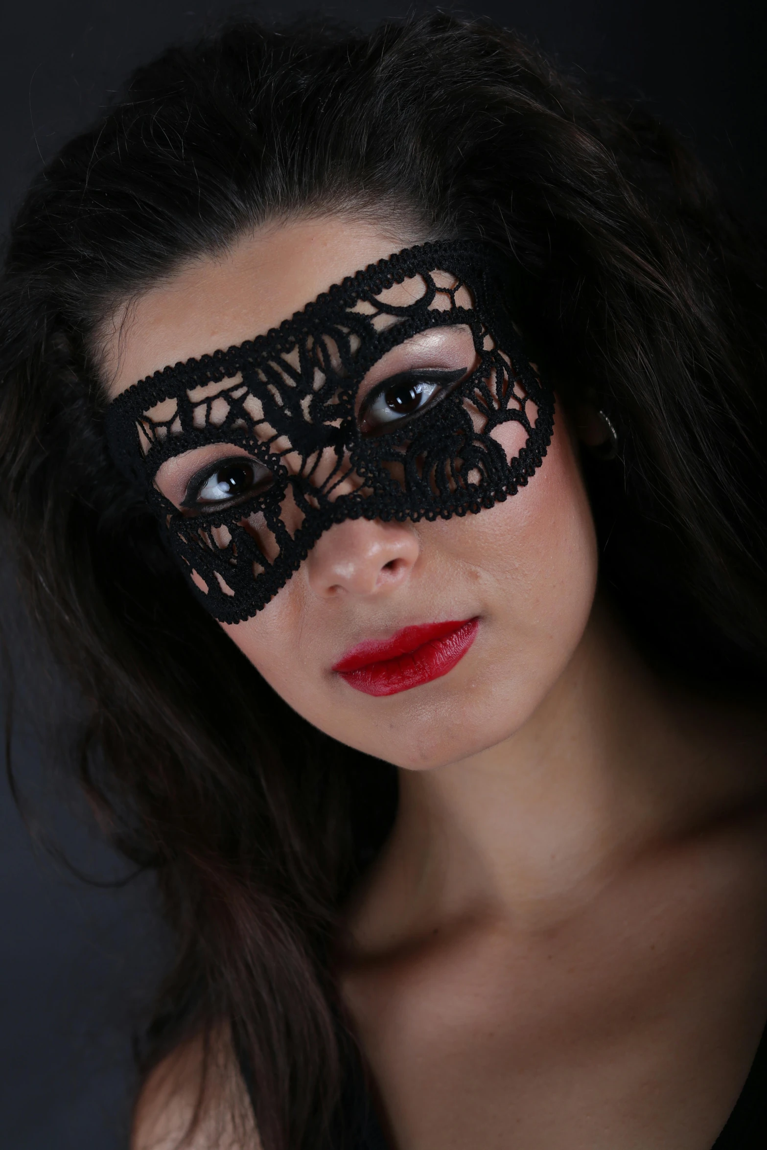 woman wearing a masquerade and red lipstick