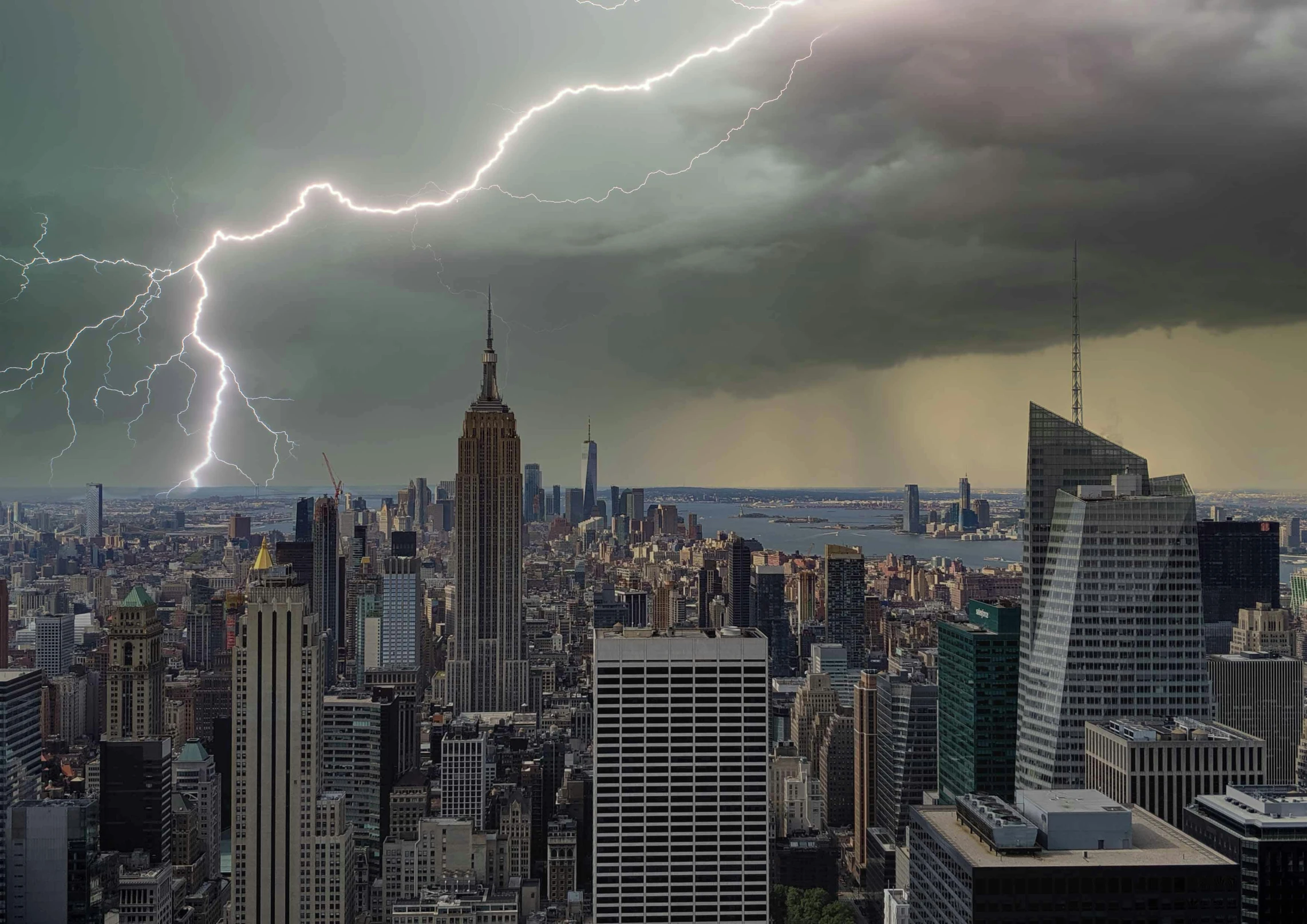 lightning hitting through a cloudy sky over new york city