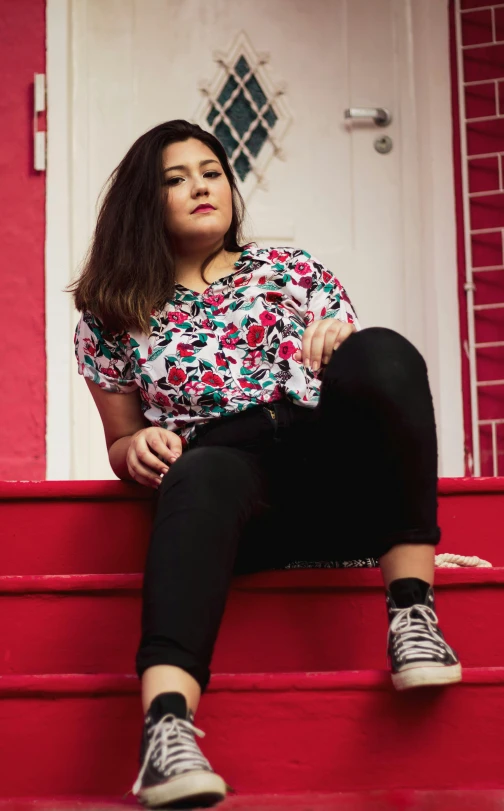 a beautiful woman sitting on a set of steps