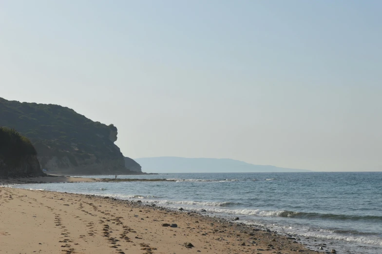 the beach is empty and has footprints in the sand