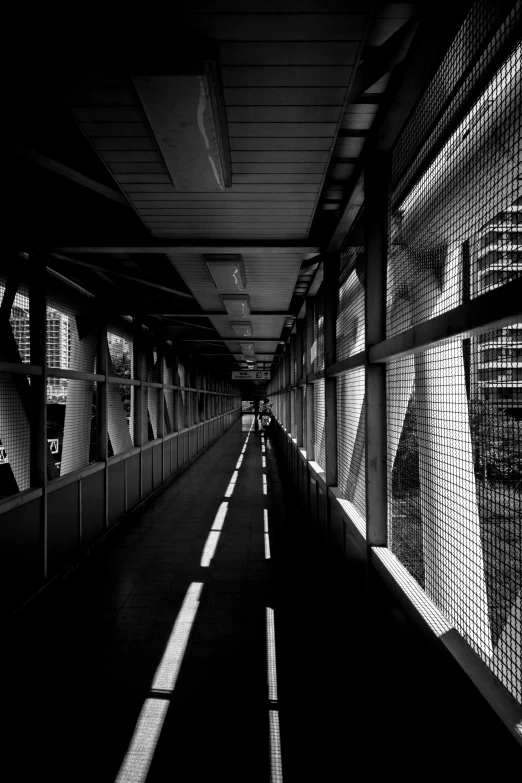 an empty long passageway filled with lots of windows