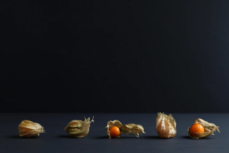 a table with seven vegetables and one orange in the center