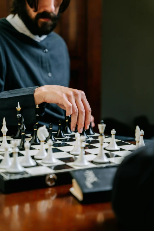 a man standing over a chess board playing games