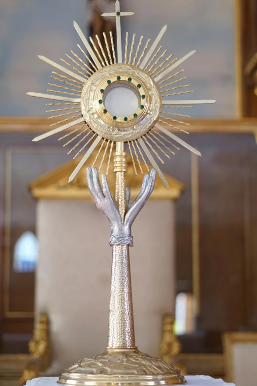 a hand that is holding the clock on it's stand