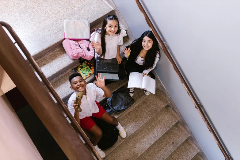 group of students sitting on the stairs at school