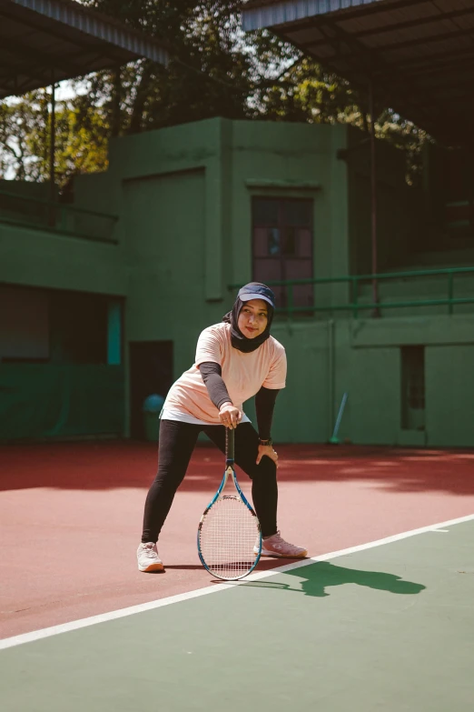 a woman getting ready to hit a tennis ball on a court