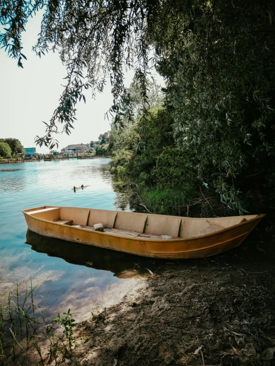 a small wooden boat that is sitting on the shore