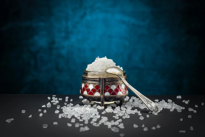 a bowl filled with sugar and a spoon