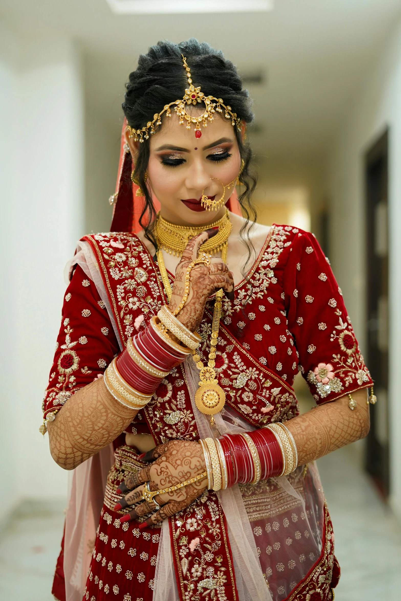 a woman dressed in red getting ready for a wedding