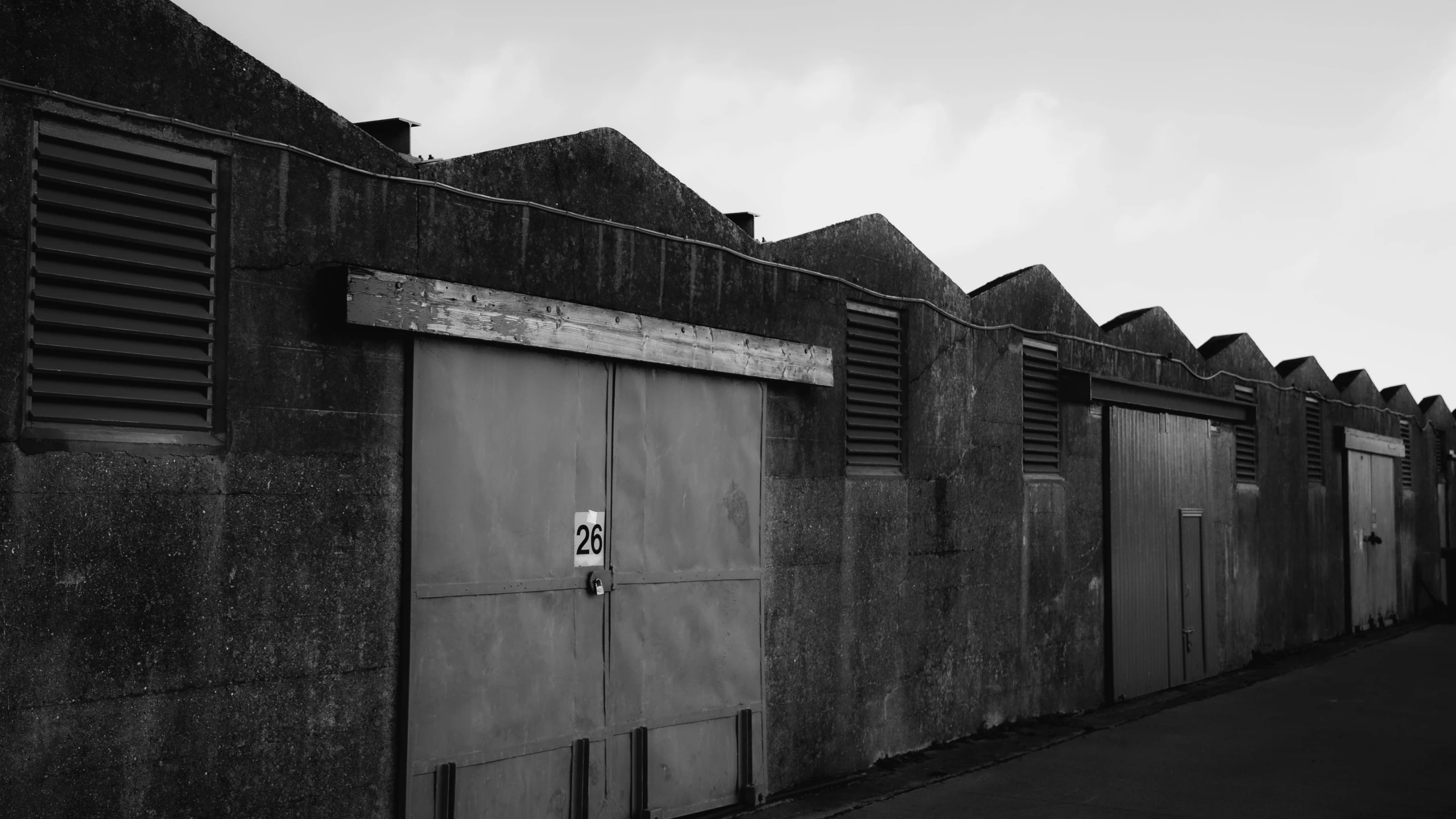 a building with a bunch of shutters and a bunch of windows