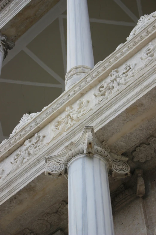 a white column with two ornate decoration on it