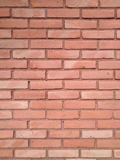 a close up of a brick wall, with red bricks on the side