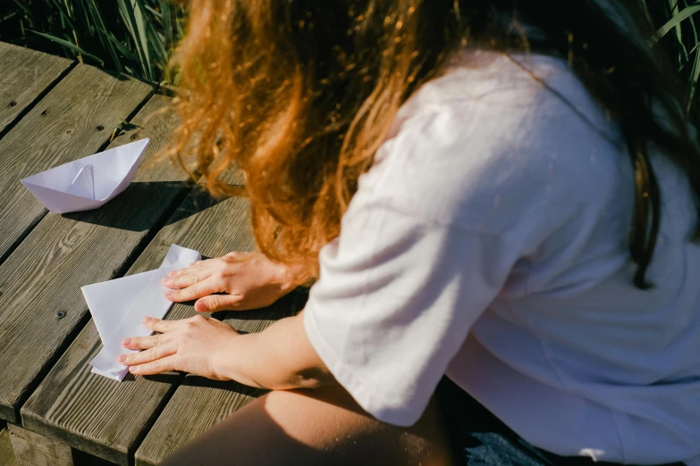  preparing craft paper boats on a small dock