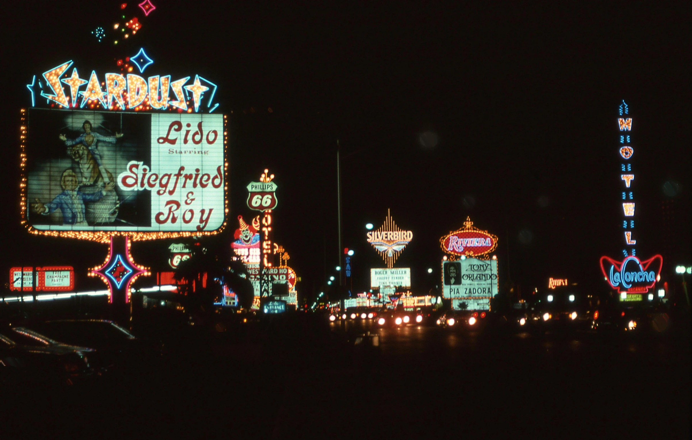 a lot of signs and lights all on the side of the road