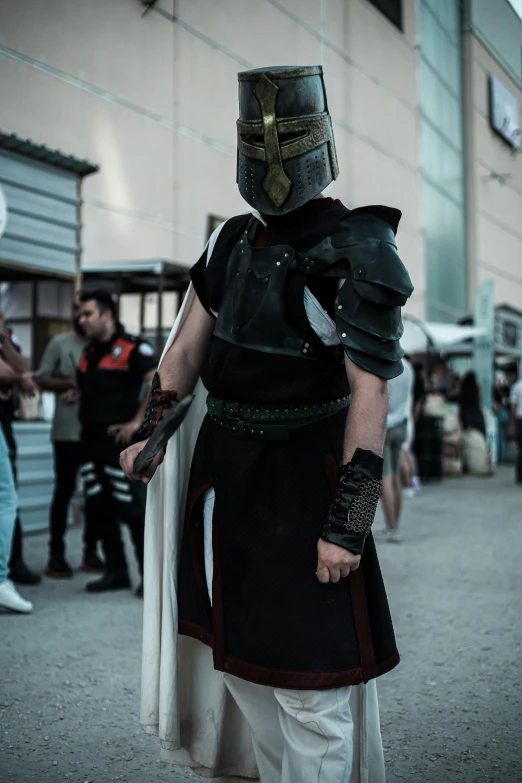 a man dressed as a spartan in an outside area