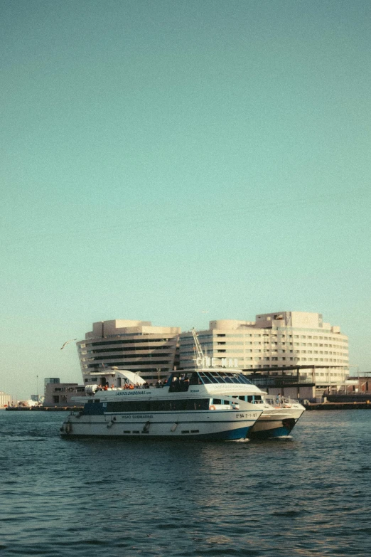 several boats sitting on top of the water near buildings