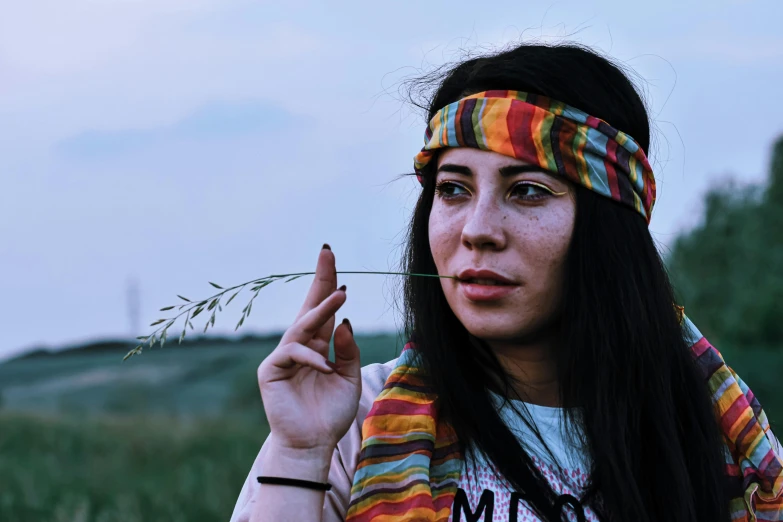 a beautiful woman with her fingers up and wearing a striped headband