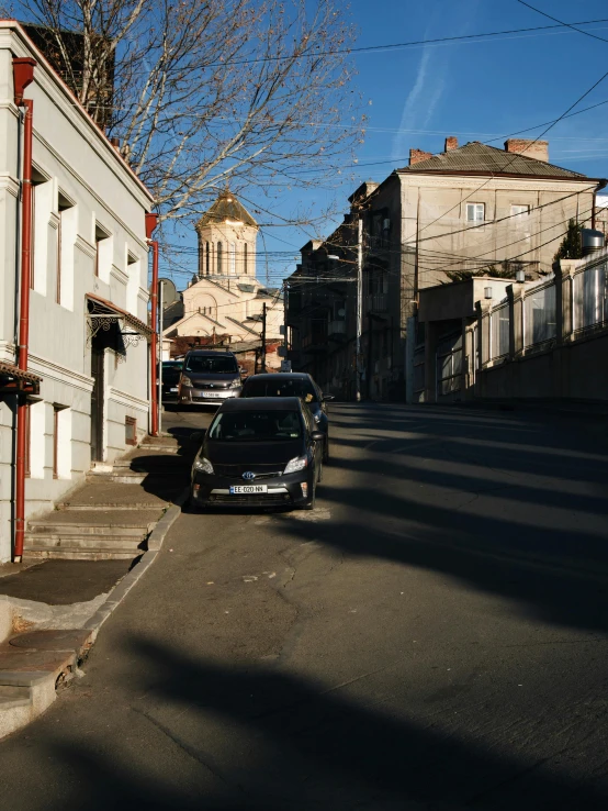 the car is parked in front of the old building