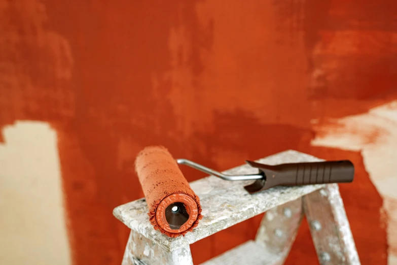 a white paintbrush sitting on top of a stool