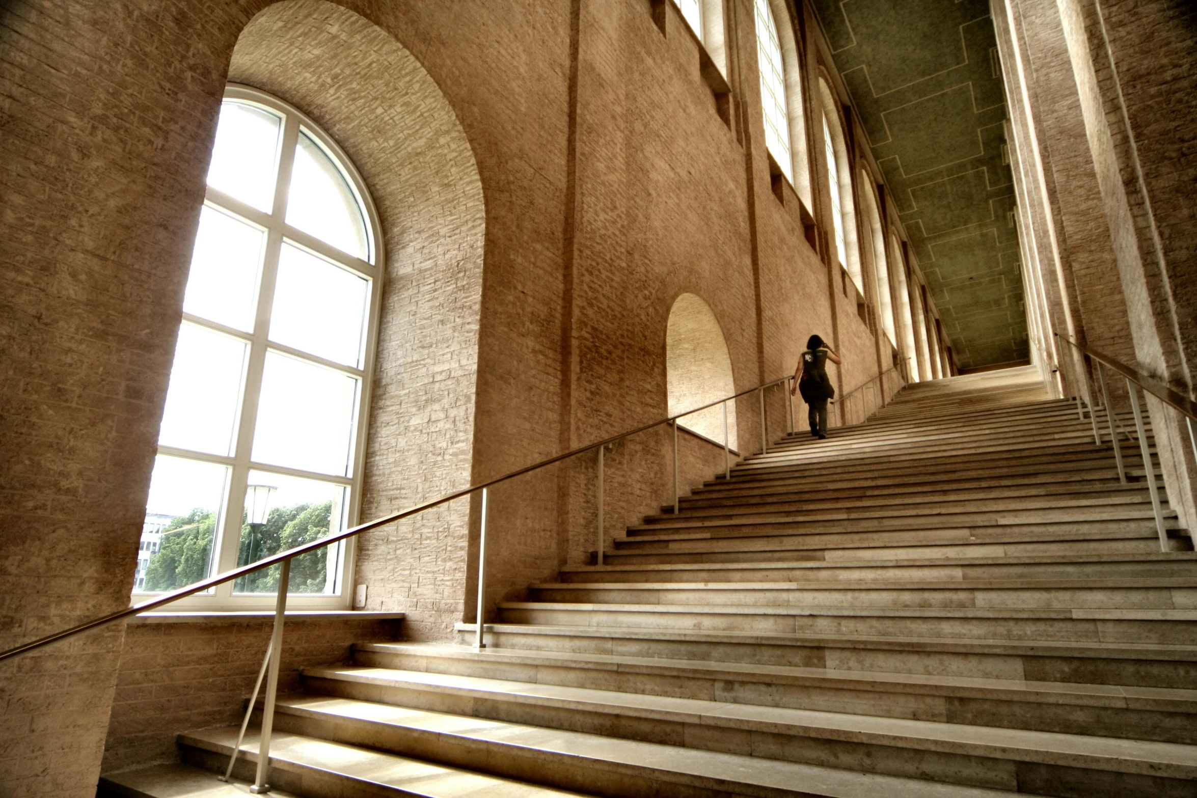 a man walks up some stairs with a long staircase