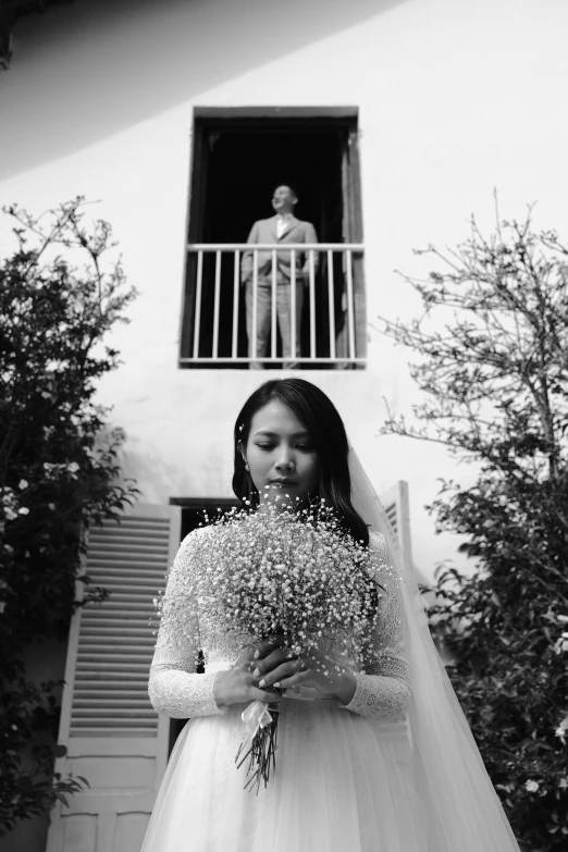 the bride holds some flowers in front of her