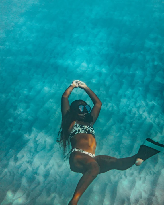 a young woman is floating in the water