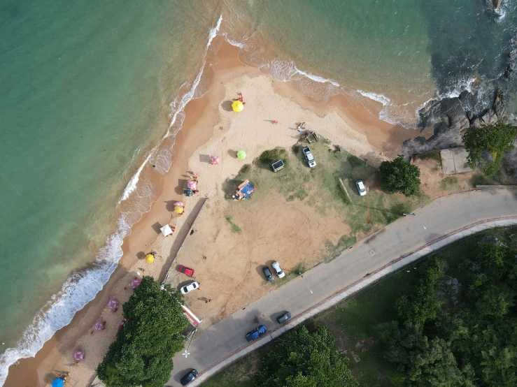 top view of sandy beach area and green water near shore