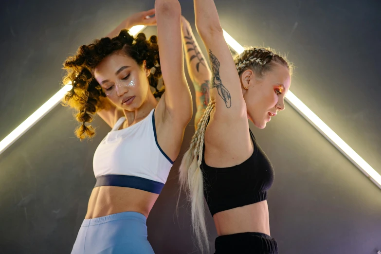 two women standing on their legs in the middle of a dance