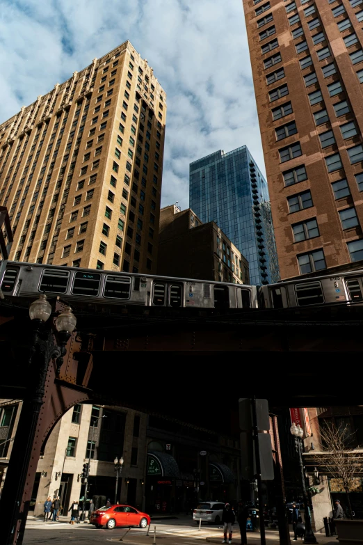 some very tall buildings towering over a street