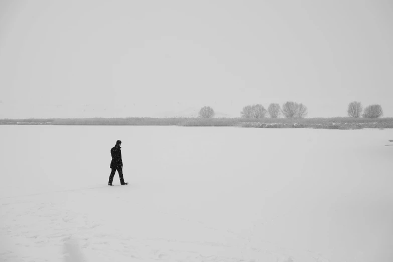 a lone person walking in the snow