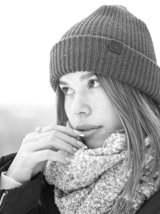 woman in hat and scarf blowing the whistle