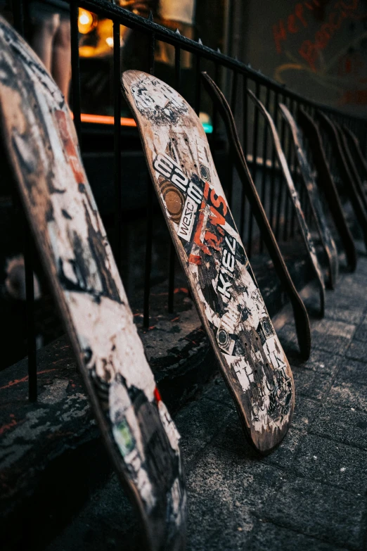 a broken skateboard that is leaning against a rail