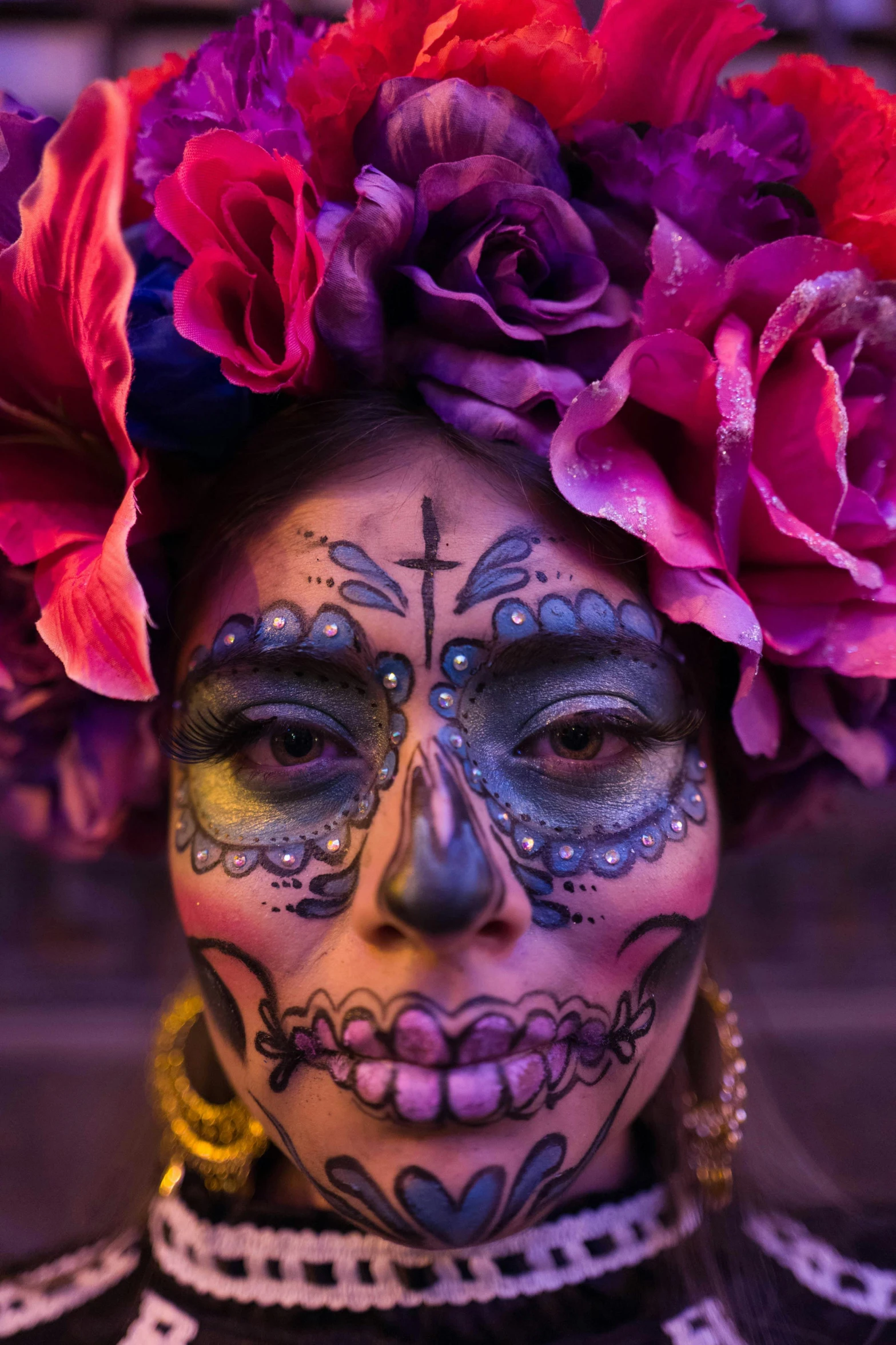 a close - up of the face of a woman decorated in flowers