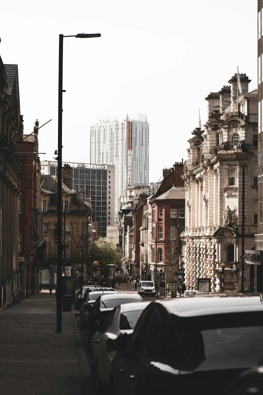 cars parked along a city street next to buildings