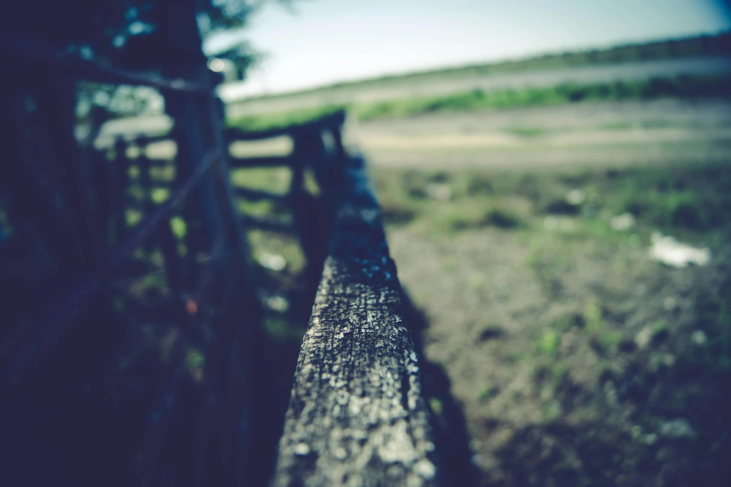 a close up s of the bench in front of an open field