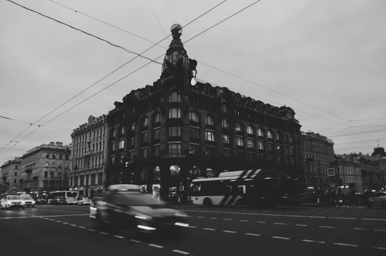 a car passing by an old building with power lines in the background